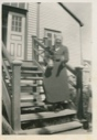 Image of Mrs. Paul Hettasch on steps of her home